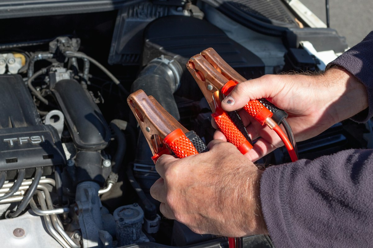 Jumper cables connected to a car battery
