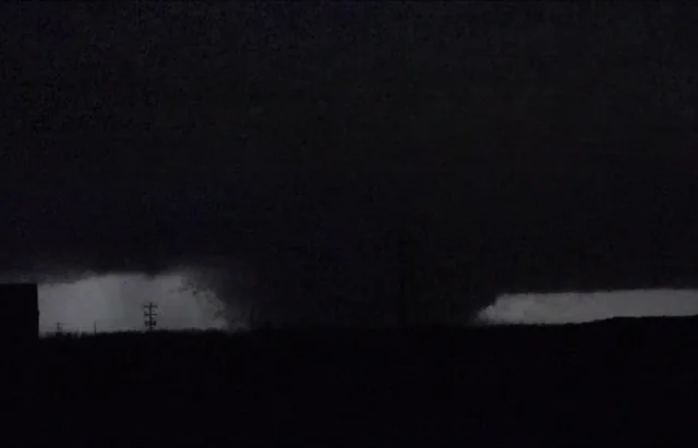Night exposure photograph from rural western Kentucky showing continuous power flash arcing along the tornado path