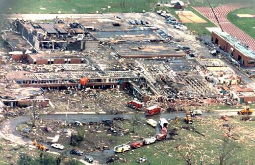 Photograph of Plainfield High School after the tornado, showing structural failure of the gymnasium roof